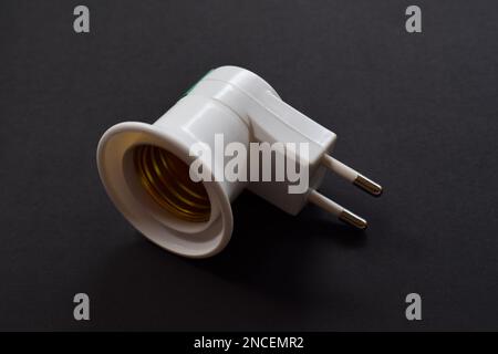 Light bulb socket isolated on a black background. with on off switch Stock Photo