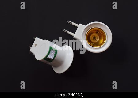 Light bulb socket isolated on a black background. with on off switch Stock Photo