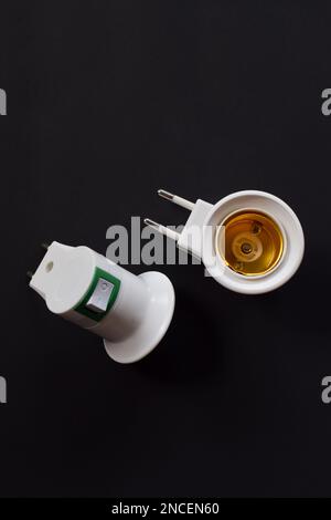Light bulb socket isolated on a black background. with on off switch Stock Photo