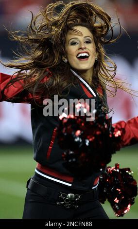 Tampa Bay Buccaneers cheerleader Ashley Woods looks through optics of a