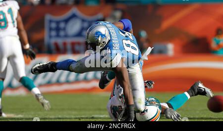 San Francisco 49ers' Sean Ryan (81) is tackled by Miami Dolphin's Channing  Crowder (52) after catching an 8 yard pass in third quarter action at  Dolphin Stadium in Miami on December 14