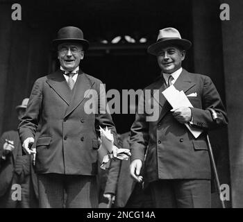 German Chancellor Dr. Heinrich Bruening, and Foreign Minister of Germany, Dr. Julius Curtius, right, leave the Foreign Office in London, United Kingdom, on July 23, 1931 at the conclusion of the Seven Power Economic Conference, wreathed in smiles. (AP Photo/Bead)