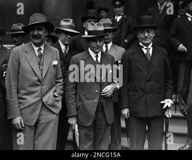 The delegates to the powers conference assembled at the Foreign office. Dr. Heinrich Bruening, right, and Dr. Julius Curtius, center, the German delegates photographed as they left the Foreign office in London, United Kingdom, for the luncheon adjournment on July 21, 1931. (AP Photo/Bead)