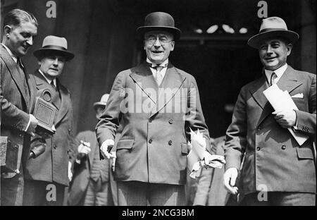 German Chancellor Dr. Heinrich Bruening, center, and Foreign Minister of Germany, Dr. Julius Curtius, right, leave the Foreign Office in London, United Kingdom, on July 23, 1931 at the conclusion of the seven power economic conference, wreathed in smiles. (AP Photo/Bead)