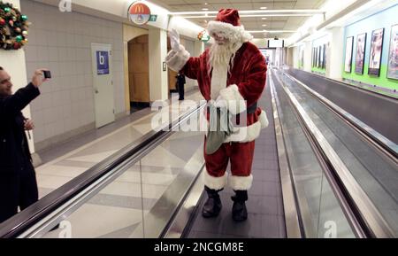 Santa, Bob Carroll, of Newtown Square, Pa., donned a Santa suit and visited  travelers at the Philadelphia International Airport on Friday, Dec. 17,  2010. To the delight of sisters, Maxine Slaymaker, age