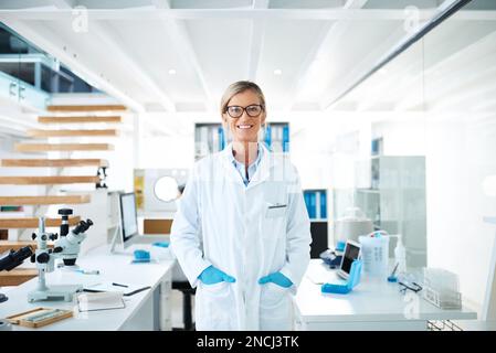 Just another bright day to make some new discoveries. Portrait of a mature scientist standing in a lab. Stock Photo