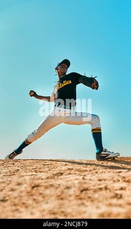 Lets see if you can hit this. a young baseball player pitching the ball during a game outdoors. Stock Photo