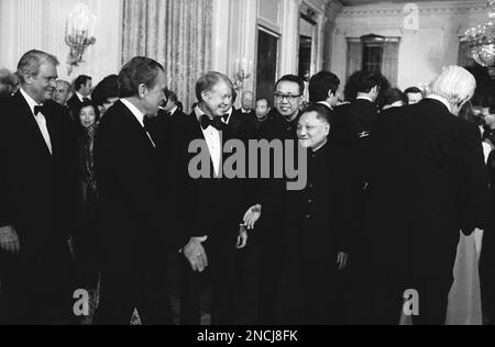 Sen. Howard Baker, R-Tenn., shakes hands with Chinese Vice Premier Teng  Hsiao-ping, right, as President Jimmy Carter and an unidentified  interpreter look on at a state dinner at the White House in