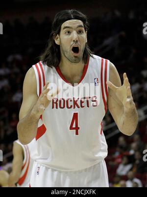 Houston Rockets' Luis Scola (4) is fouled by the Los Angeles