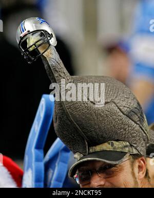 A Detroit Lions fan wears a turkey hat for Thanksgiving during an NFL  football game against the Houston Texans at Ford Field in Detroit,  Thursday, Nov. 22, 2012. (AP Photo/Rick Osentoski Stock