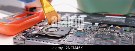 Maintenance laptop engineer holding dust brush closeup Stock Photo