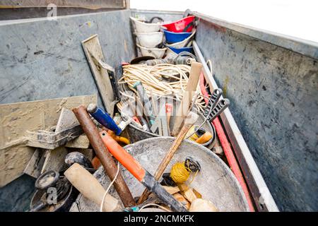 Steel crate, container, toolbox overfull of many different tools were placed in the truck trailer on the construction site. Stock Photo