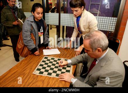 Former World Chess Champion, Garry Kasparov, right, talks to the