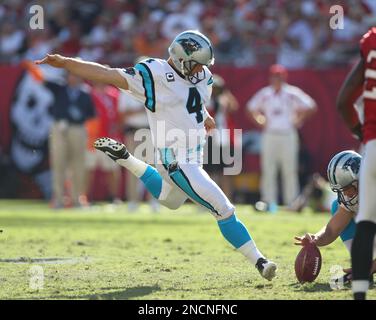 Carolina Panthers place kicker John Kasay, center, is consloed by teammates  punter Jason Baker, left, and guard Mackenzy Bernadeau (73), right, ater  missing a field goal that would have won the game