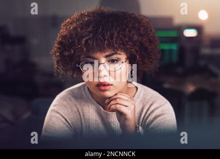Black woman, face and night business in dark office with glasses for reading or data analysis. Software engineer, IT technician or developer thinking Stock Photo