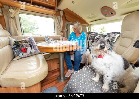 Renowned commercial artist Jo Scott abandons her studio to improve work life balance. Working anywhere in her state of the art, connected motorhome Stock Photo