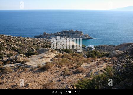 Ios, Greece - June 1, 2021 : Panoramic view of a luxury whitewashed villa and a beautiful empty sandy beach in Ios Greece Stock Photo