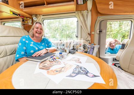 Renowned commercial artist Jo Scott abandons her studio to improve work life balance. Working anywhere in her state of the art, connected motorhome Stock Photo