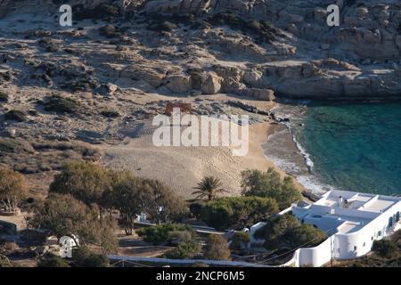 Ios, Greece - June 1, 2021 : Panoramic view of a luxury whitewashed villa and a beautiful empty sandy beach in Ios Greece Stock Photo