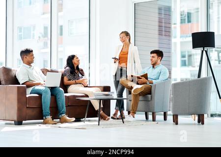 Delivering excellence through teamwork. a group of businesspeople having a discussion in an office. Stock Photo