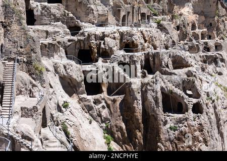 Caves and tunnels linked with stairs and ladders in Vardzia Cave monastery complex in Georgia, mountain slope with carved underground city. Stock Photo