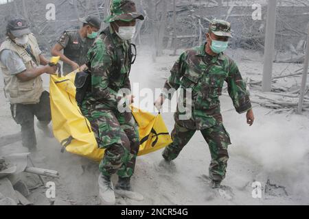 Rescuers carry the body of a victim of Mount Merapi eruption in ...