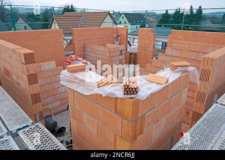 Scaffolded single-family house under construction Stock Photo