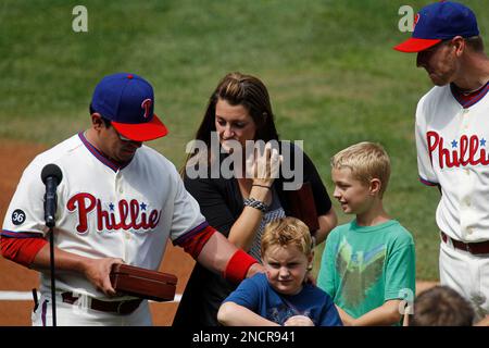 Philadelphia Phillies pitcher Roy Halladay, accompanied by his wife Brandy  and two sons, is honored during a ceremony for his perfect game against the  Florida Marlins in May, before the Phillies' baseball