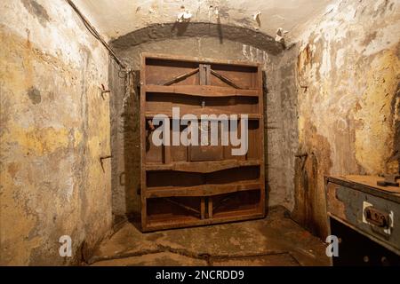 Hermetic rusty door of the bunker in underground abandoned tunnel. Mysterious old iron gate. Secret entrance Stock Photo