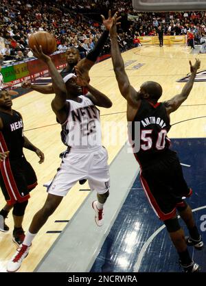 New Jersey Nets Anthony Morrow 22 is defended by Miami Heat s Joel Anthony 50 as he takes a shot in the first half during an NBA basketball game at the Prudential Center