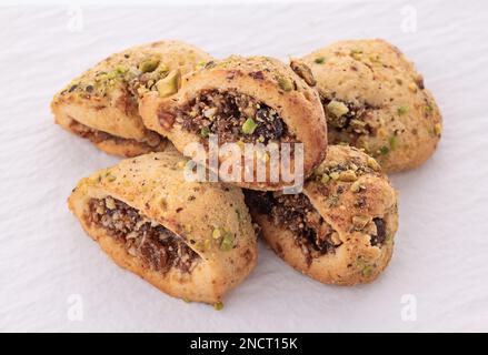 Italian homemade cookies cuccidati with nuts and jam isolated on white background Stock Photo