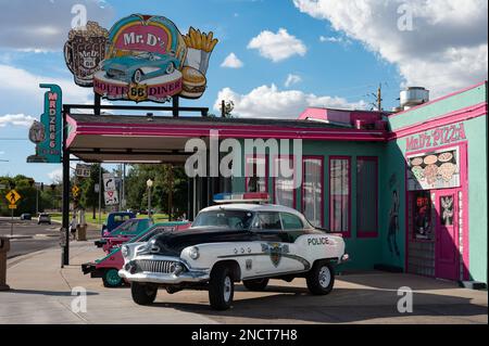 An old 1952 Buick Super Riviera Special of the police, it is raised and parked in front of a restaurant Stock Photo