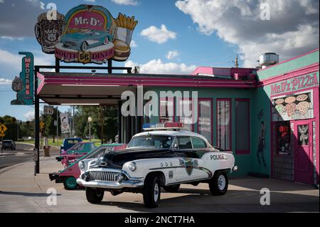 An old 1952 Buick Super Riviera Special of the police, it is raised and parked in front of a restaurant Stock Photo