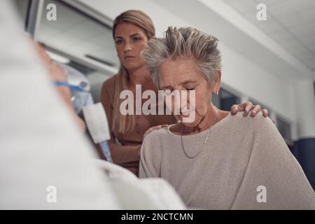 Sad woman visit her sick husband in hospital with the support and comfort from their daughter. Healthcare, love and senior female sitting and praying Stock Photo