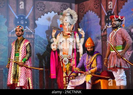 MAHARARSHTRA, PUNE, September 2022, Standing statue of Lord Ganesha and artist playing a role of Shivaji Maharaj performing at Ganesh pandal during Ga Stock Photo