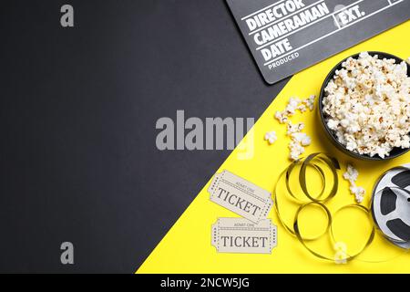 Flat lay composition with clapperboard, popcorn and cinema tickets on color background, space for text Stock Photo