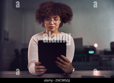 Tablet, programmer and woman in night office, research or programming online in workplace. Information technology, developer and female coder with Stock Photo