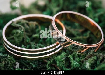 Wedding rings lying on green grass Stock Photo
