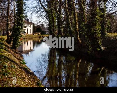 Old Lock House and winter trees reflected in Ripon Canal Ripon North Yorkshire England Stock Photo