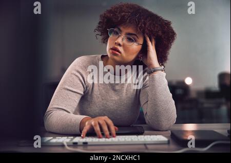 Thinking, confused and night with a black woman programmer working late in her office for cybersecurity. Idea, doubt and overtime with a female Stock Photo
