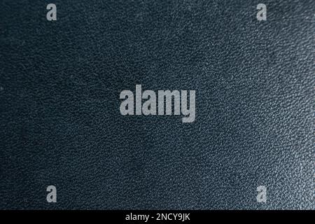 a black leather texture closeup with a light point on the right side Stock Photo