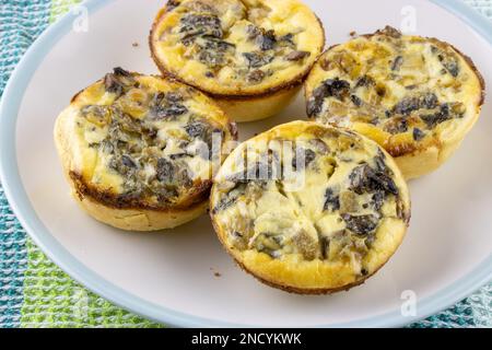 Home made small mushroom tartlets on a plate closeup with selective focus Stock Photo