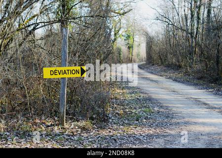 Diversion sign on the forest gravel road in a France shows to the right. Stock Photo