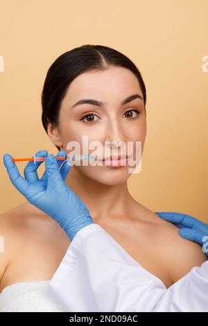 Cosmetology Treatment. Young Indian Woman Getting Lip Augmentation Injection Stock Photo