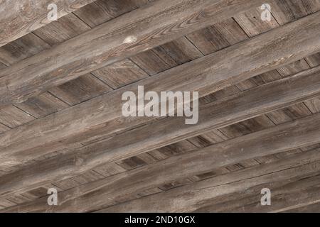 Underside view of an old wooden floor structure of a building damaged by woodworm holes Stock Photo
