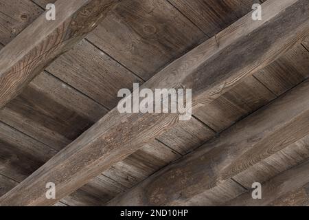 Underside view of an old wooden floor structure of a building damaged by woodworm holes Stock Photo