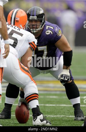 Green Bay Packers' Aaron Rodgers (12) throws with Baltimore Ravens' Kelly  Gregg (97) rushing during the