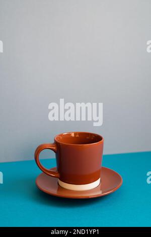 Brown coffee cup on blue table Stock Photo