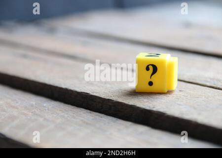 Question mark on a yellow cube. Place for text. Vintage style. Stock Photo