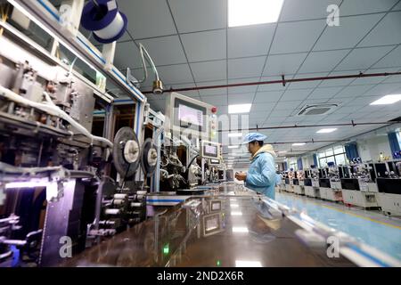 ZIXING, CHINA - FEBRUARY 14, 2023 - Workers work at an automated production workshop of Huihua Electronics Co LTD in Zixing Economic Development Zone, Stock Photo